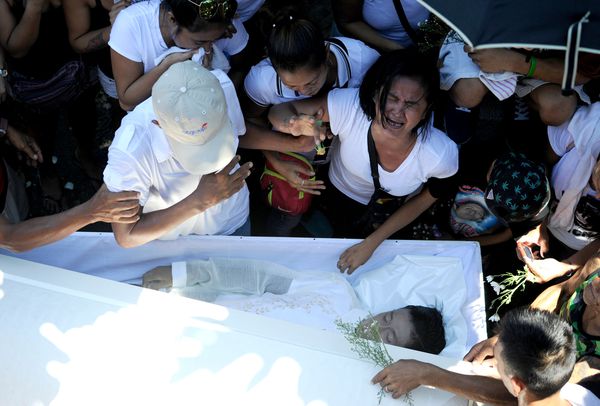 Jennilyn Olayres cries at the coffin of her partner Michael Siaron, an apparent victim of President Rodrigo Duterte's call for vigilantes to kill all the country's drug dealers.