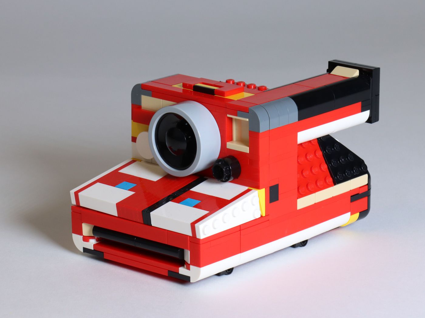 This particular red, gray, black, white, and yellow Lego Polaroid prototype was made from the colors that were on hand.
