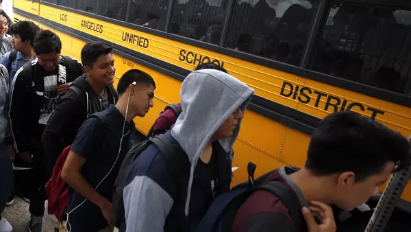 Students line up for a school bus on the first day of school in Los Angeles this year.