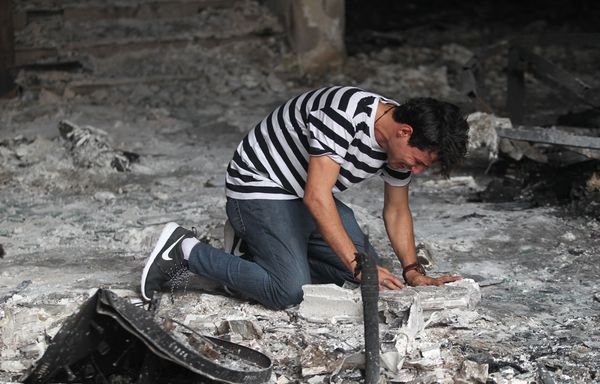 A man in a building destroyed by the ISIS bombing in Baghdad.